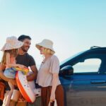 Happy Family Preparing for a Summer Vacation on a Beachside Road