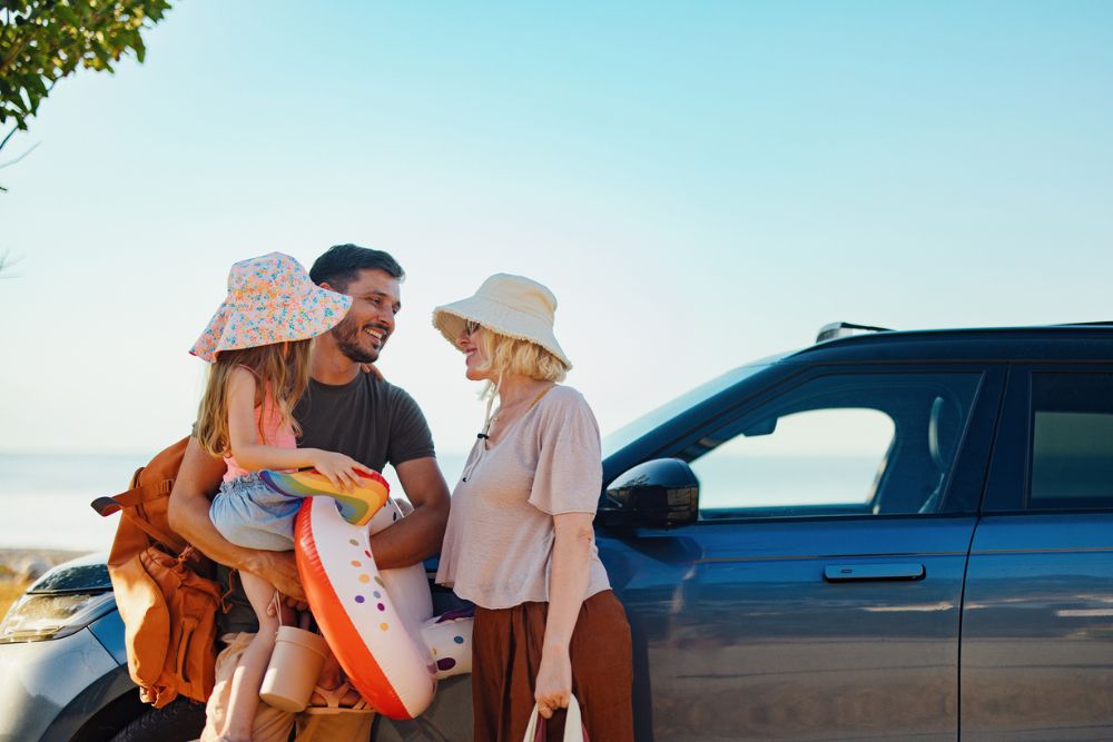Happy Family Preparing for a Summer Vacation on a Beachside Road
